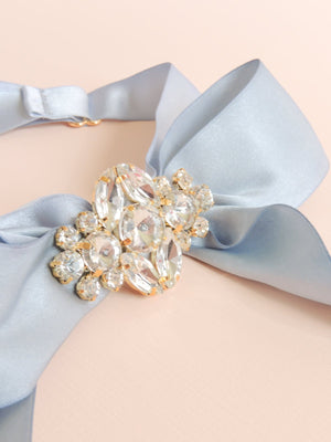 Mamie and James Amelie adjustable silk bow wedding garter in french blue with rhinestone appliqué in gold tone setting